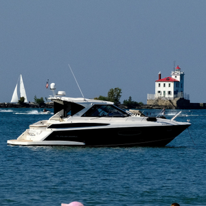 Powerboat and the Fairport Harbor West Breakwater Light